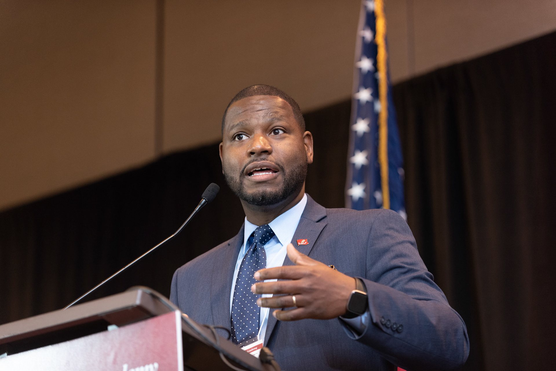 Donald Harris speaking at a podium